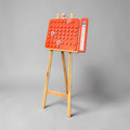  orange calendar on a wooden stand against a gray background