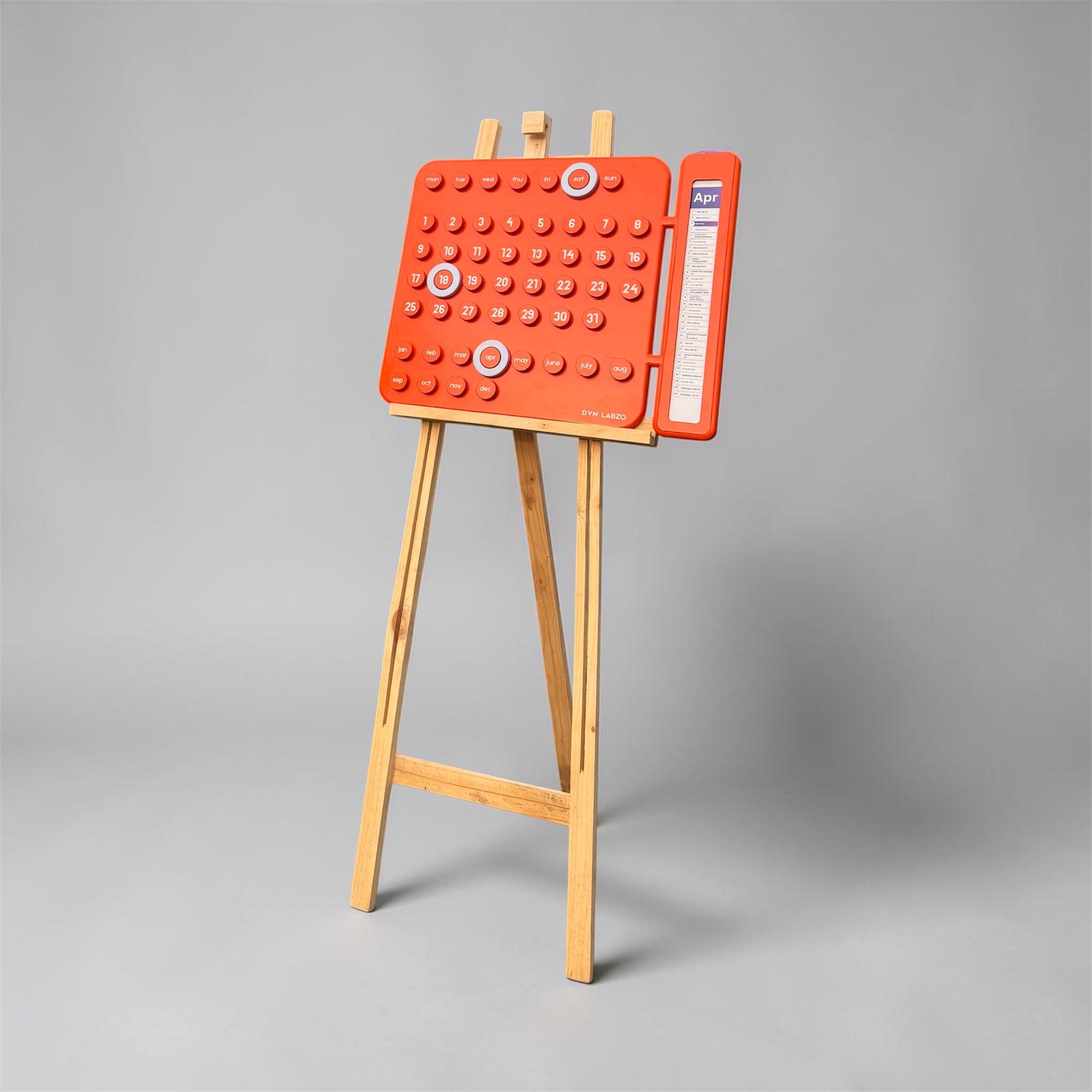  orange calendar on a wooden stand against a gray background