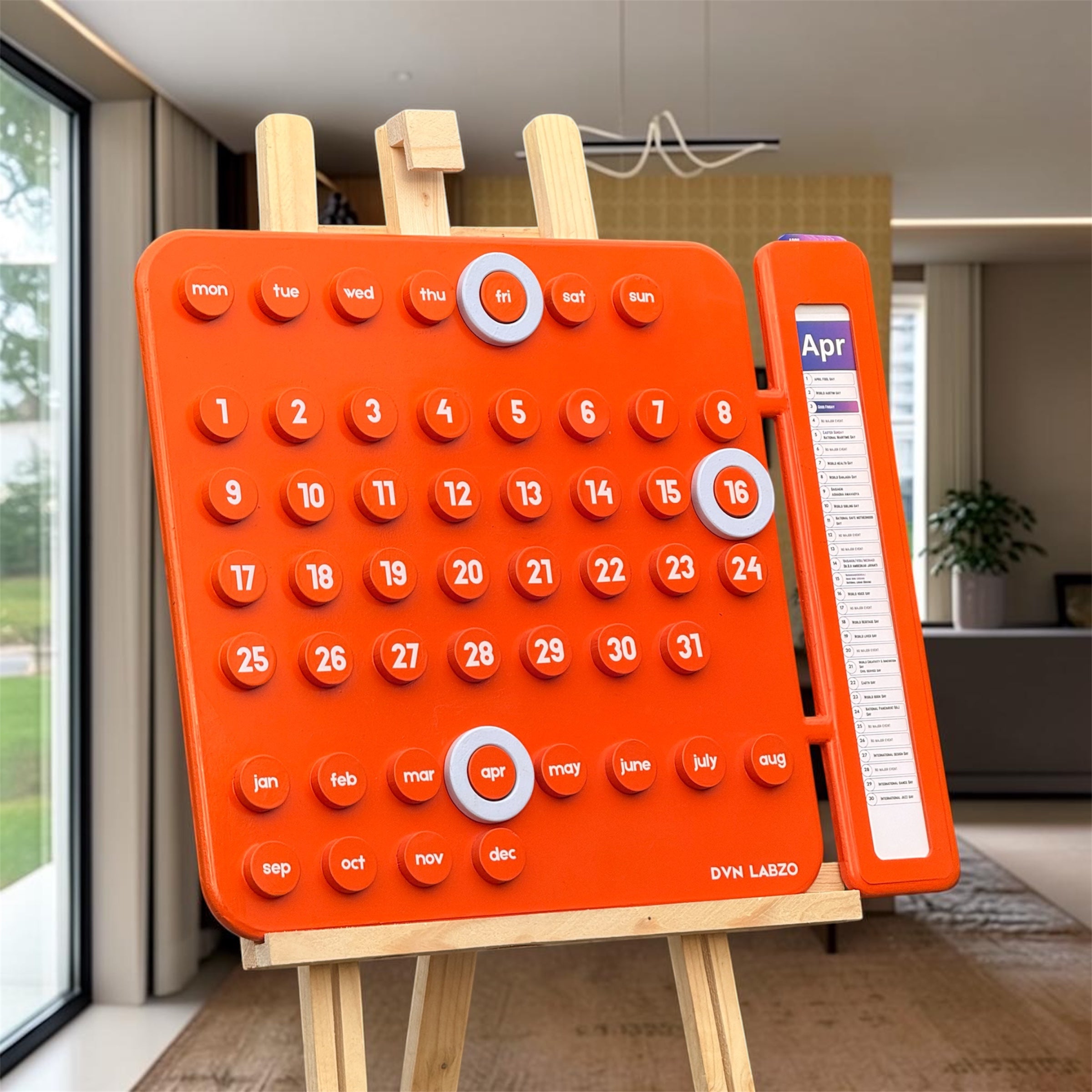 Orange children's calendar on a stand in a room with a window and plant.